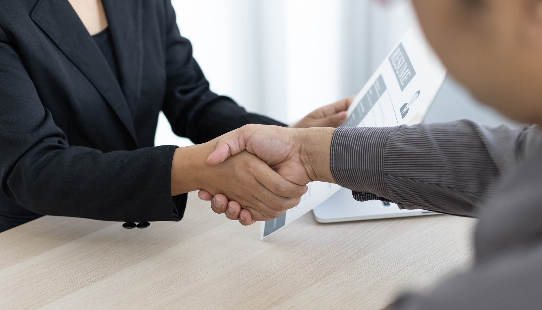 Handshake between Human Resources Manager and Applicant